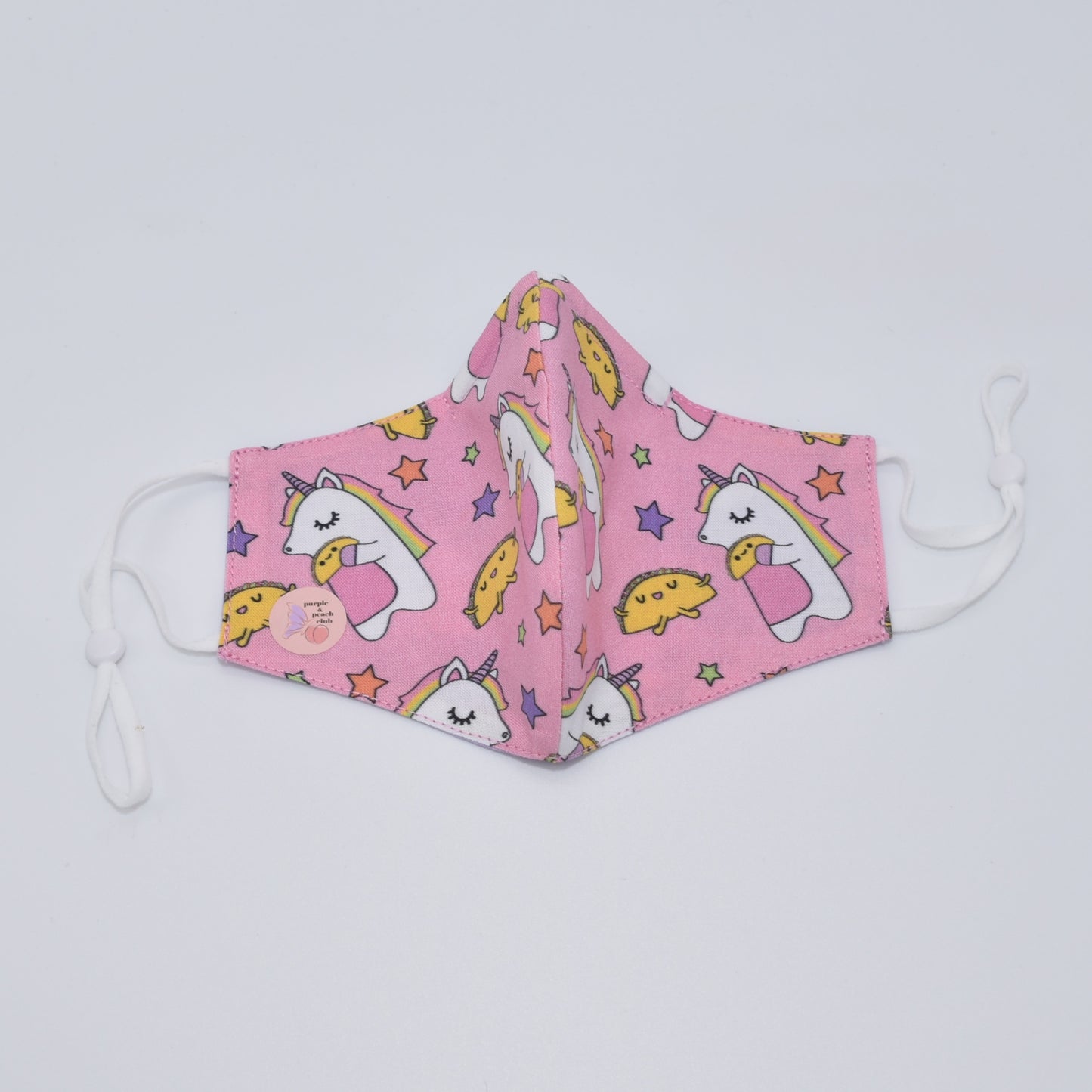 This unicorns and tacos print cotton face mask is reversible and double-layered, built for comfort with an adjustable nose bridge and adjustable ear straps.