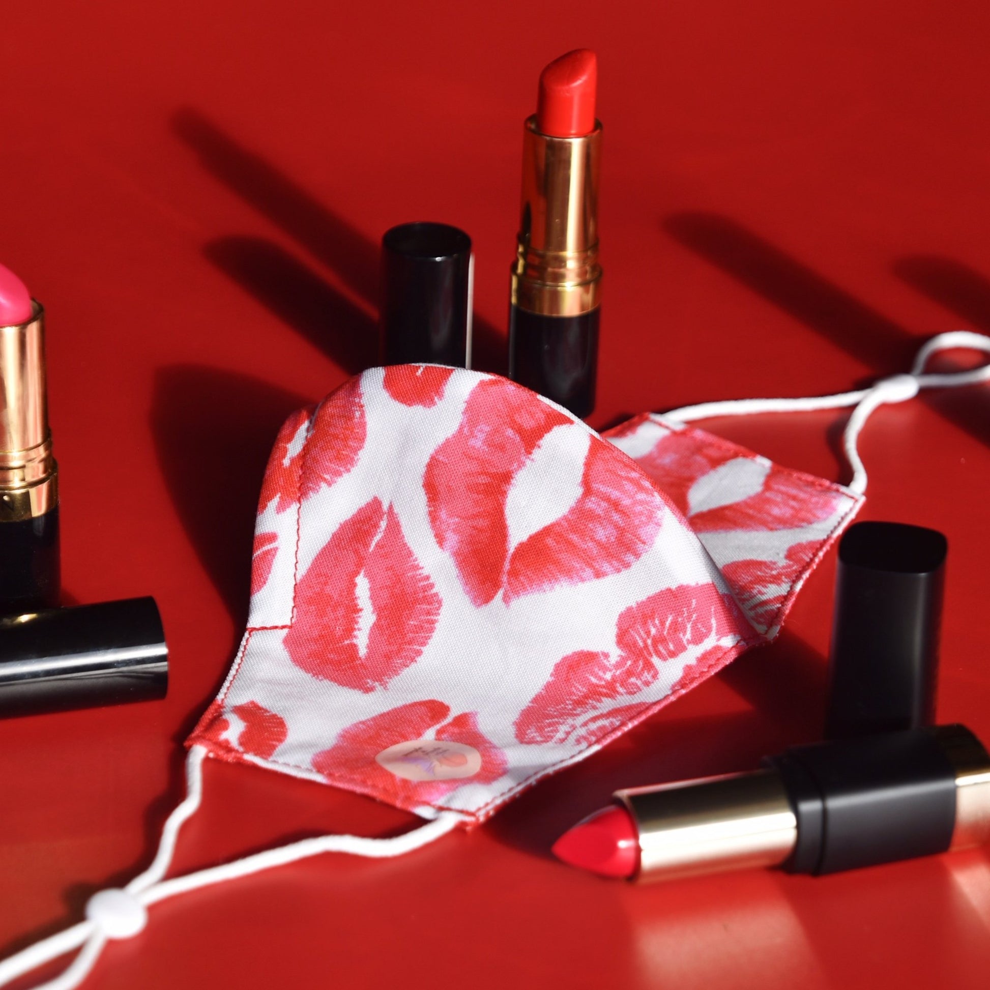 The playful and chic cotton print makes this mask a fashion statement all on its own, perfect for those missing the soft and luxurious feeling of applying a coat of deep red lipstick.   Made with one of our heavier-weight cotton novelty fabrics to provide a sturdier outer shell and the ultimate combination of both structure and comfort. Reversible and double-layered. Built with an adjustable nose bridge and adjustable ear straps.