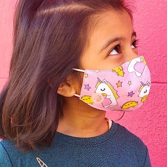 This unicorns and tacos print cotton face mask is reversible and double-layered, built for comfort with an adjustable nose bridge and adjustable ear straps.