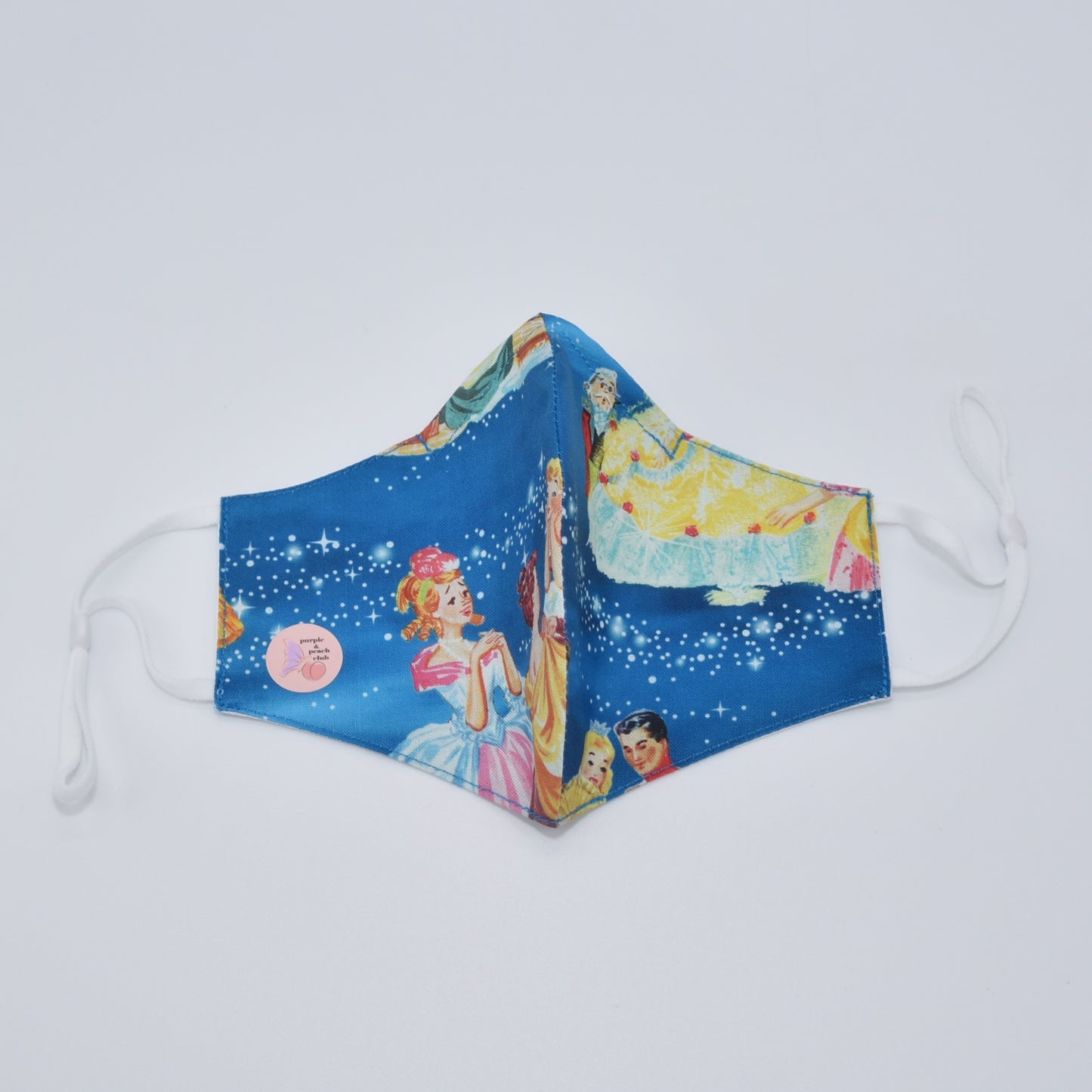 This cinderella print cotton face mask is reversible and double-layered, built for comfort with an adjustable nose bridge and adjustable ear straps.