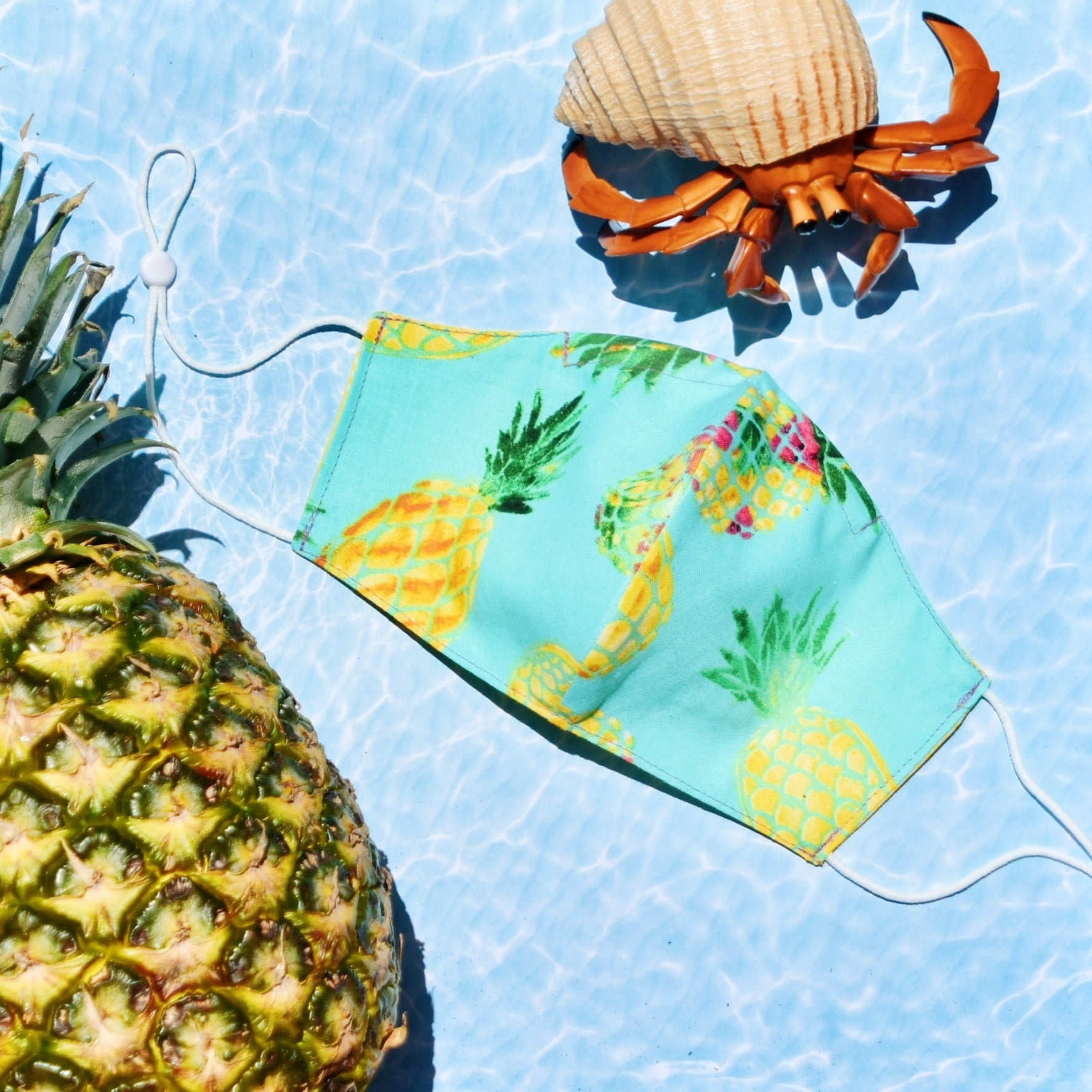 The cotton fabric’s vibrant shades of turquoise and yellow on our eye-catching pineapple print mask lets you take summer with you wherever you go.  Reversible and double-layered. Built for comfort with an adjustable nose bridge and adjustable ear straps. 